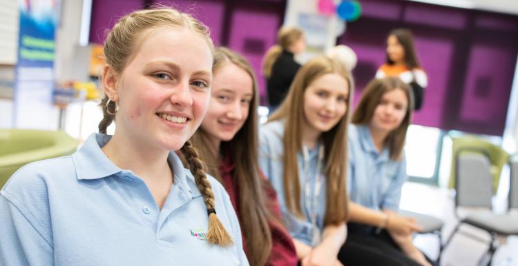 Group of young girls sitting in a row