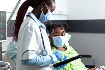 Doctor talking to child in hospital ward