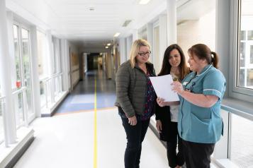 Family members speaking to a hospital worker